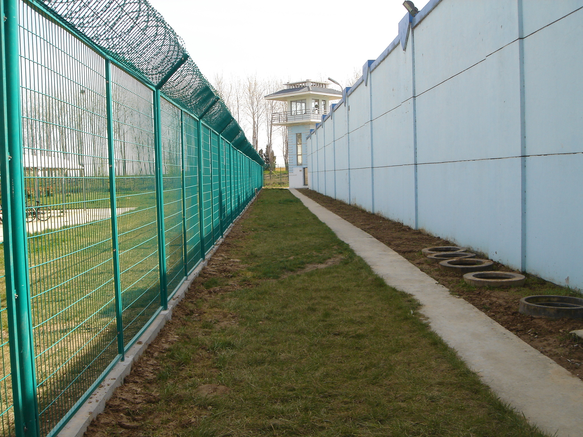 prison-fence-watch-tower-and-barbed-roberto-westbrook